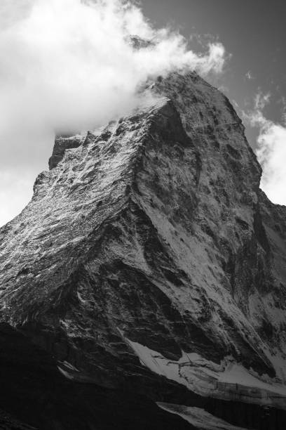 istock Vertical shot of a cloudy mountain peak in grayscale 1432198841