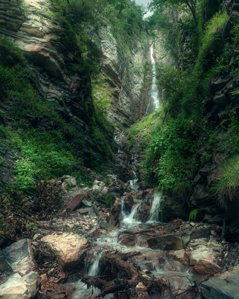 istock Vertical view of the waterfall flowing through the stones cascade 1432199483