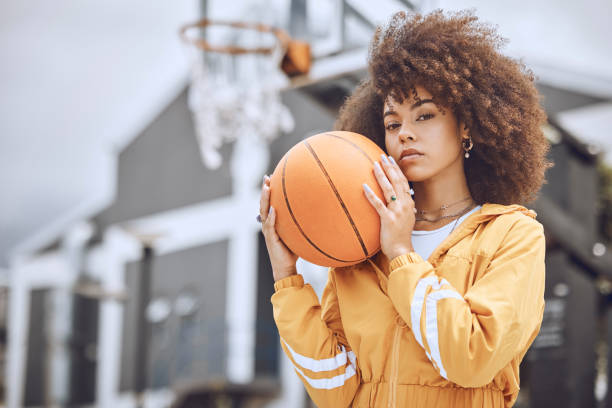 istock Cool basketball player with funky, confident and hipster attitude ready for game, fun or playing outdoor sports match. Portrait of young, fashion and beautiful black woman with afro ready for fitness 1432199516