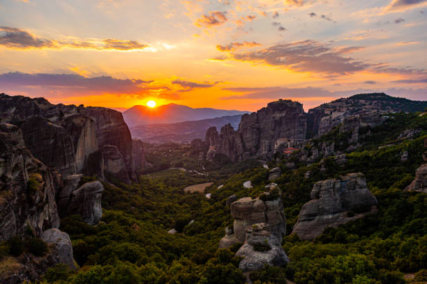 istock Idyllic view of Meteora monastery and forest against orange sky during sunset 1432199651