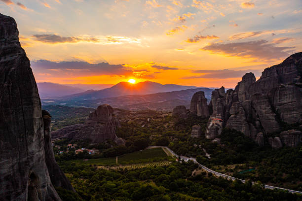 istock Scenic view of Meteora monastery against orange sky during sunset 1432199658