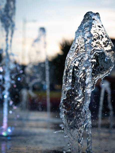 istock Vertical shot of fountain water splashing on a blurry background 1432200205