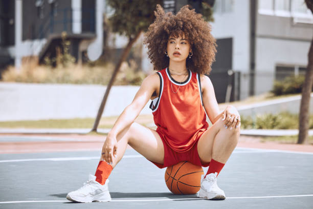 istock Basketball player with funky, confident and cool attitude ready for competition, game or fit training match on a sports court. Beautiful black woman, healthy athlete and motivation female with afro 1432203081