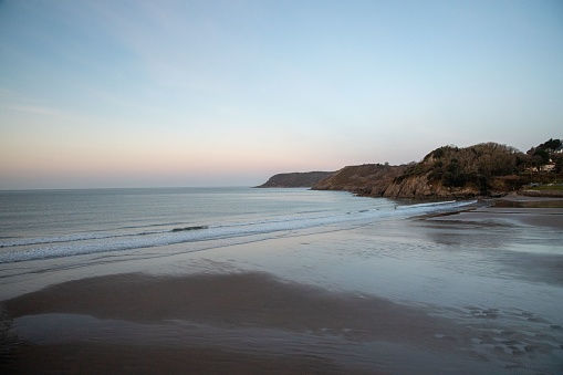 Empty seaside beach at evening in Fujian province, China. Wind turbines