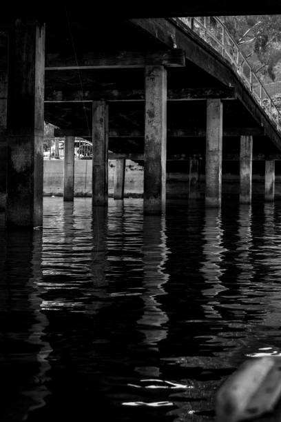 istock Vertical black and white shot of an old bridge reflected on the water 1432204612