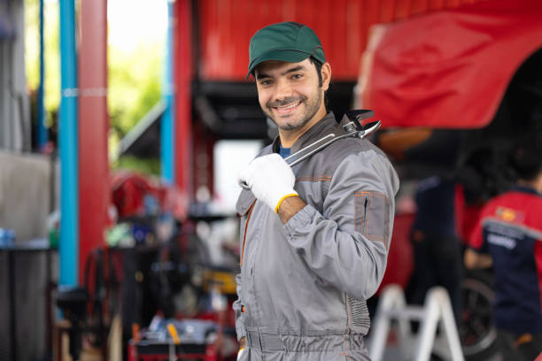 istock Portrait engine maintenance car mechanic with holding wrench self-confident with looking at camera. diagnostic and repairing vehicle at garage automotive, Car care check and fixed services concept. 1432204651