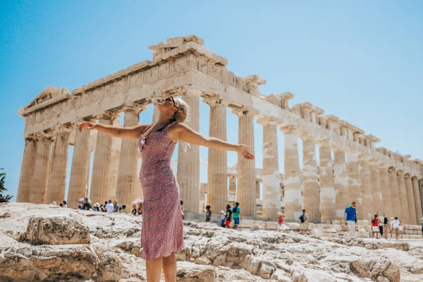 istock Young woman enjoying summer while standing against Parthenon temple 1432204855