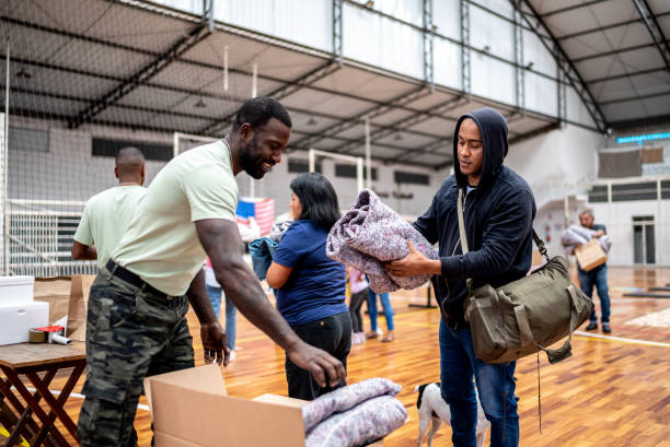istock Young man receiving a blanket from a soldier at community center 1432207461