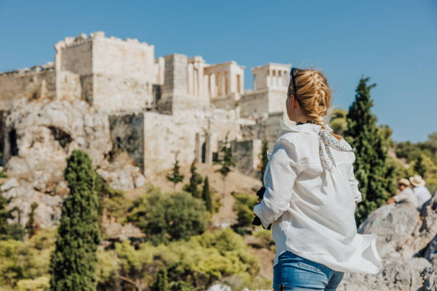 istock Woman standing at Areopagus rock while looking at Acropolis against sky 1432207705