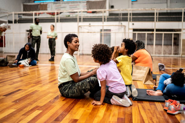 istock Soldier talking to  refugee children 1432208044