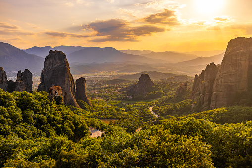 Scenic view of famous Meteora monastery against cloudy sky during sunset