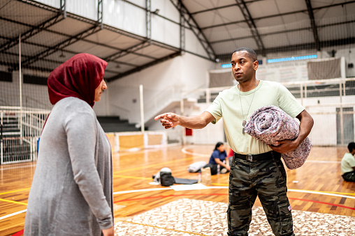 Soldier talking to a refugee woman at a community center