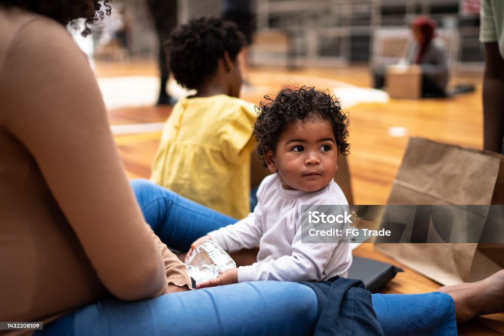 Baby boy with mother in a refugee sheltering Homelessness Stock Photo