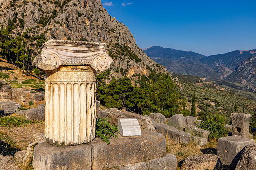 View of old ruins of Greek temple against mountain during summer