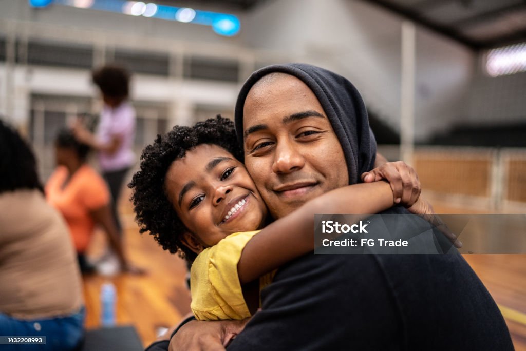 Portrait of father and daughter embracing at a community center Family Stock Photo