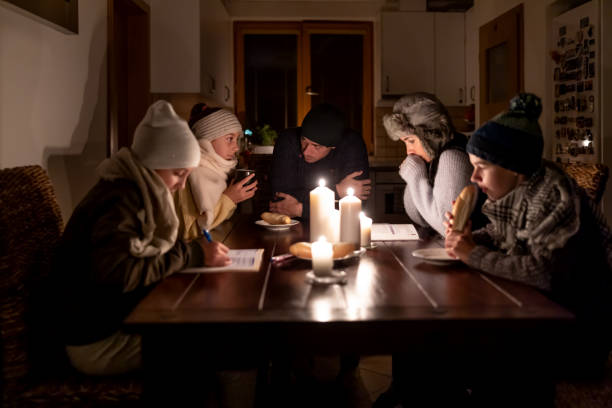 Family of five suffers in no heating and no electricity during an energy crisis in Europe causing blackouts. stock photo