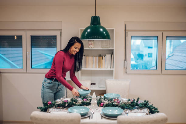 istock Middle aged woman decorating and setting the table for Christmas dinner 1432209734