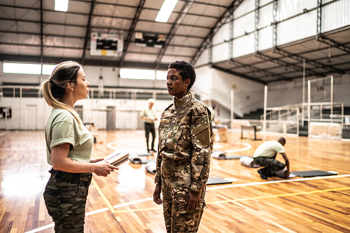 Female soldiers talking at a gymnasium