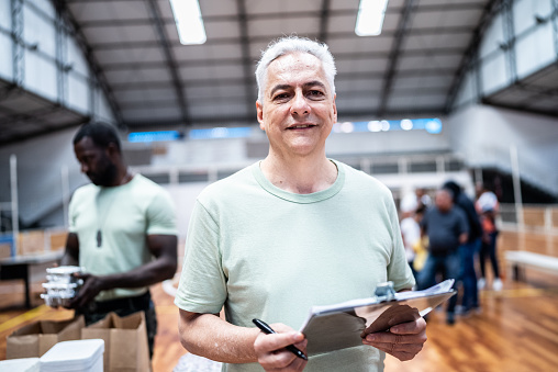 Portrait of a male soldier holding a clipboard at a gymnasium