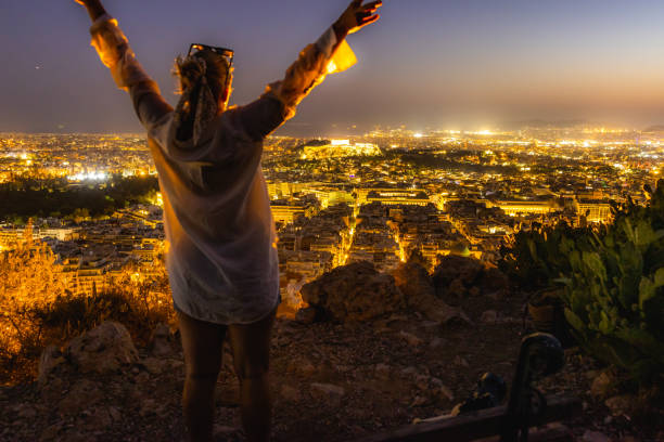 istock Woman exploring beautiful illuminated cityscape against sky during dusk 1432210058