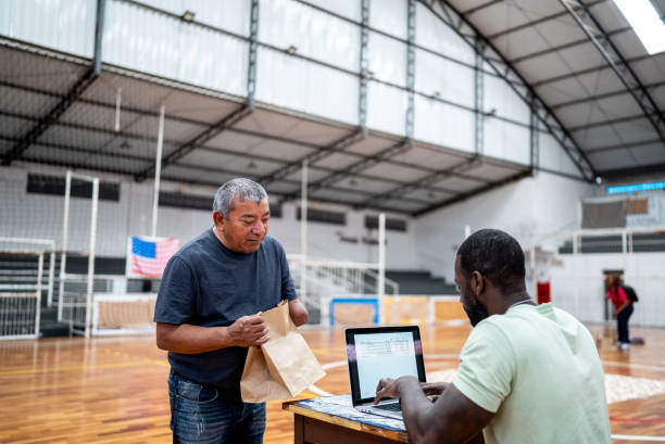 istock Soldier talking with a refugee disability man while using the laptop at a refugee sheltering 1432210279