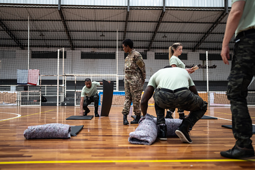 Soldiers preparing sleeping bags in a sheltering