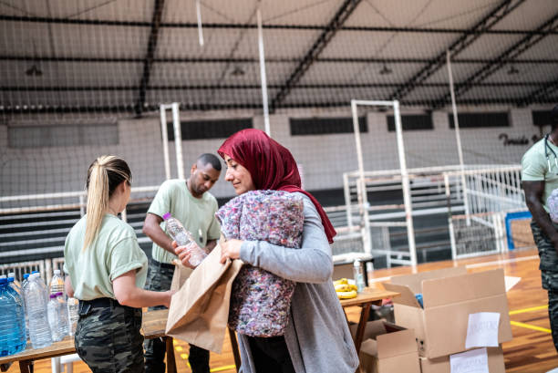 Soldiers giving donations to refugees in a sheltering