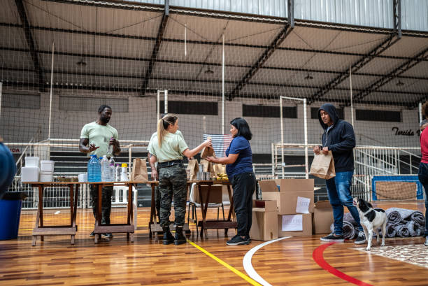 istock Soldiers giving donations to refugees in a sheltering 1432210997