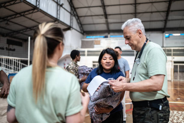 istock Soldier with a clipboard giving donations to refugees in a sheltering 1432211024