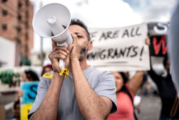 istock Mature man talking in a megaphone during a protest in the street 1432212182