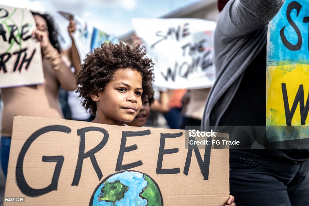 Boy protesting in the street 8-9 Years Stock Photo