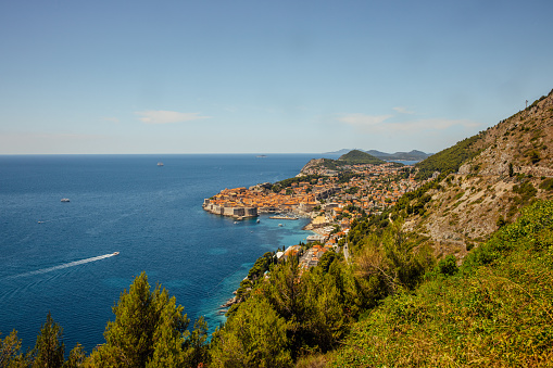 Beautiful view of coastal town with blue sea against sky on sunny day