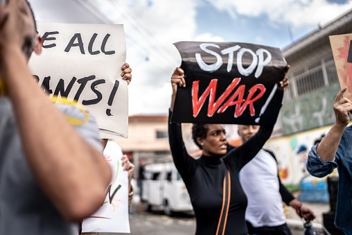 Mature woman protesting against war in the street