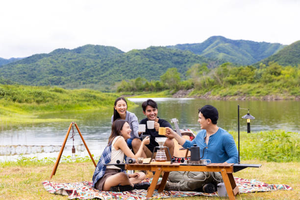 istock Group of Asian people having breakfast drinking coffee while camping together at nature park. 1432215770