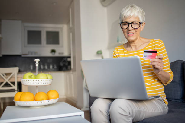 istock Woman using her credit card to shop online 1432215949