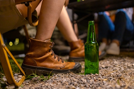 Group of Happy Asian people enjoy and fun outdoor lifestyle hiking and camping together on holiday travel vacation. Man and woman friends cooking food and having dinner near the tent at summer night.