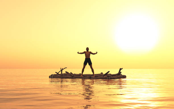 Castaway on a raft at sunset stock photo