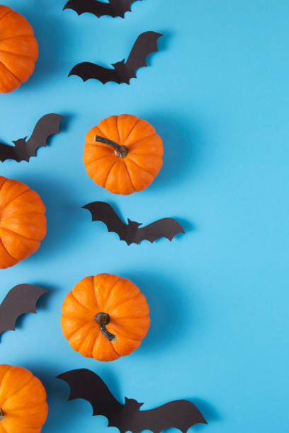 istock Halloween Decorations Pumpkins and Bats on Blue Background 1432219780