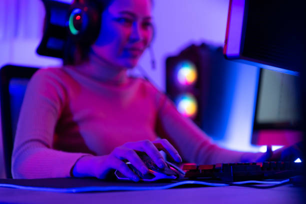 istock An active and serious young woman gamer on his powerful personal computer, playing first-person online video games. 1432220070