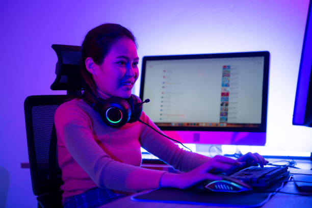 istock An active and serious young woman gamer on his powerful personal computer, playing first-person online video games. 1432220081