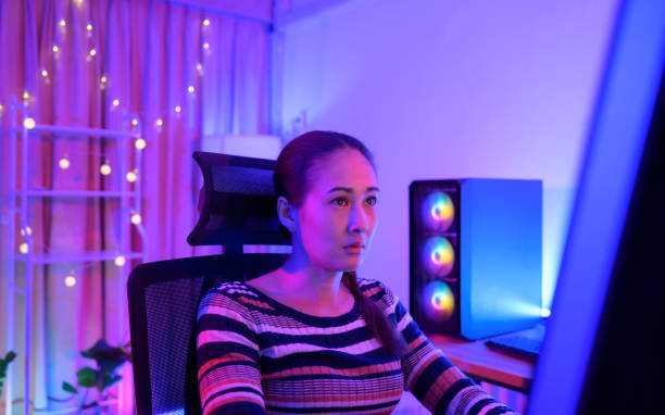 istock An active and serious young woman gamer on his powerful personal computer, playing first-person online video games. 1432220167