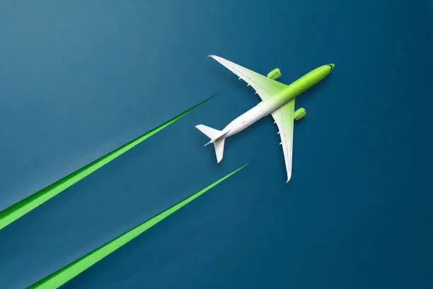 Green and white Aircraft with condensation trail in the form of a cut cardboard