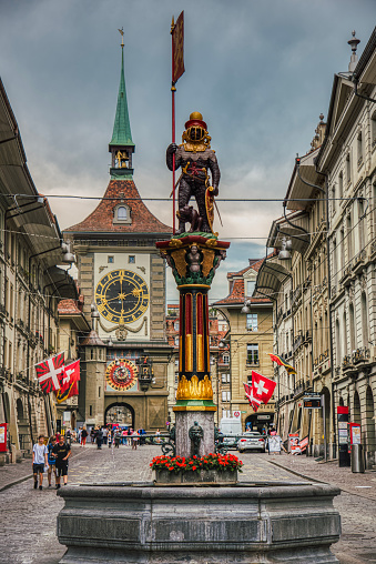Bern, Switzerland 06 03, 2019\nZahringerbrunnen in the popular Kramgasse. Historical landmark that shows a strong bear on baroque column or decorated pillar honouring the city 's founder. Power concept