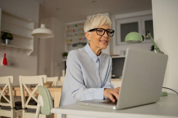 istock Senior woman working from home 1432220839