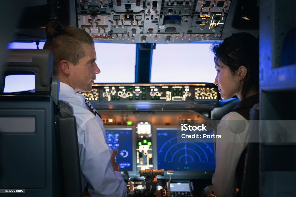 Simulator Instructor Flight Instructor Explaining How Simulator Works To A Female Student ...
