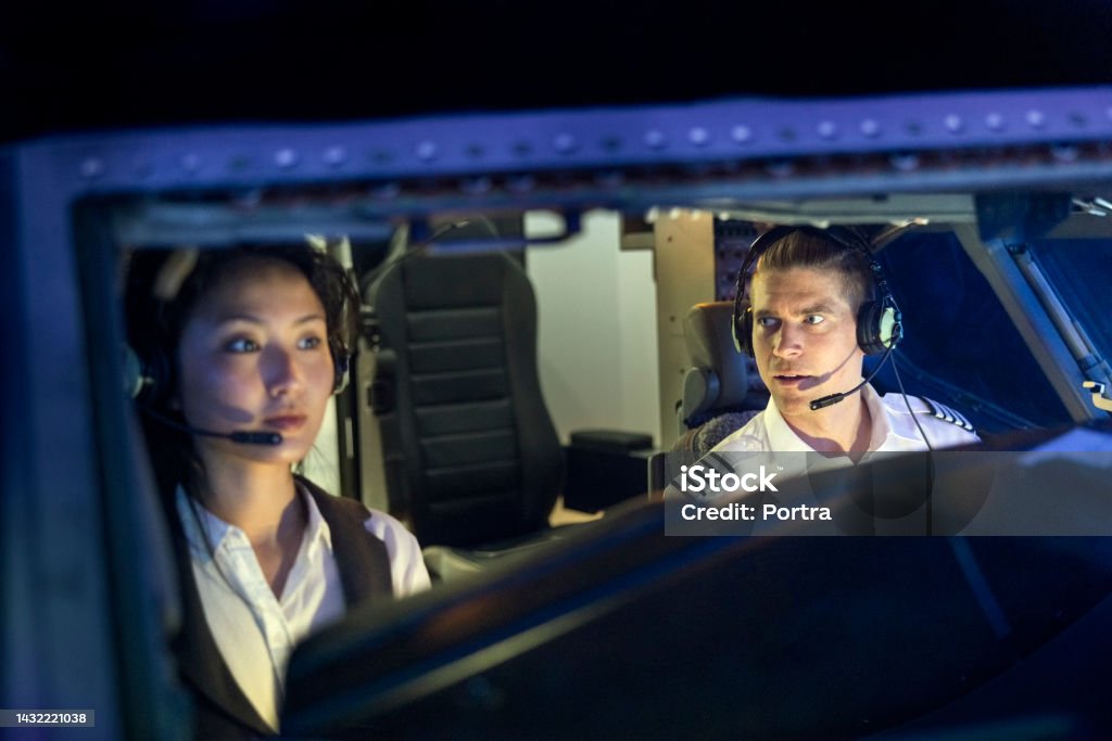 Instructor Talking With Trainee Pilot Sitting Inside A Flight Simulator ...