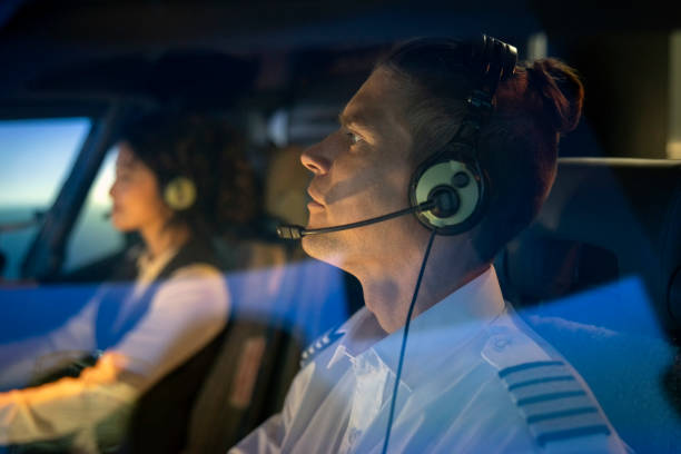 istock Pilots wearing headsets inside airplane cockpit 1432221597