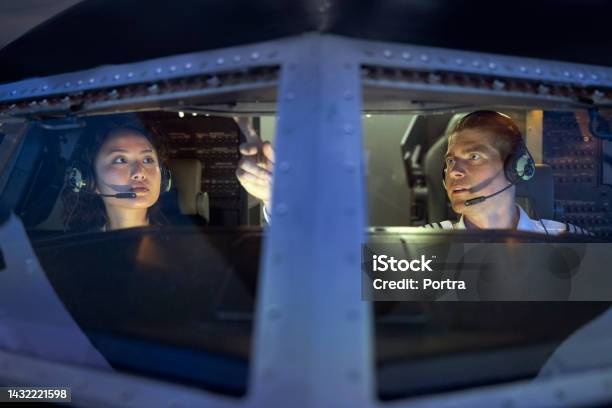 Pilot Teaching A Female Student To Fly A Plain Inside A Flight Simulator Stock Photo - Download Image Now