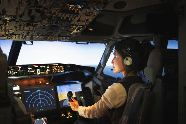 rear view of a woman pilot flying an airplane - airplane cockpit taking off pilot imagens e fotografias de stock