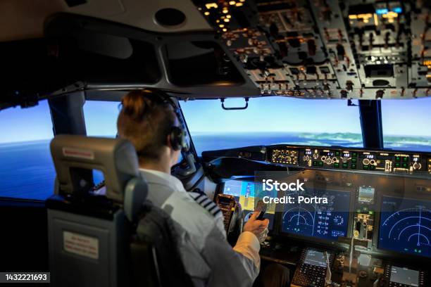Male Pilot In Cockpit Of Airplane Jet Stock Photo - Download Image Now - Pilot, Piloting, Airplane